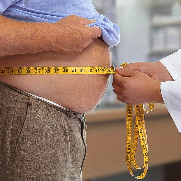 bigstock-doctor-measuring-obese-man-wai-111682115_1_621x621